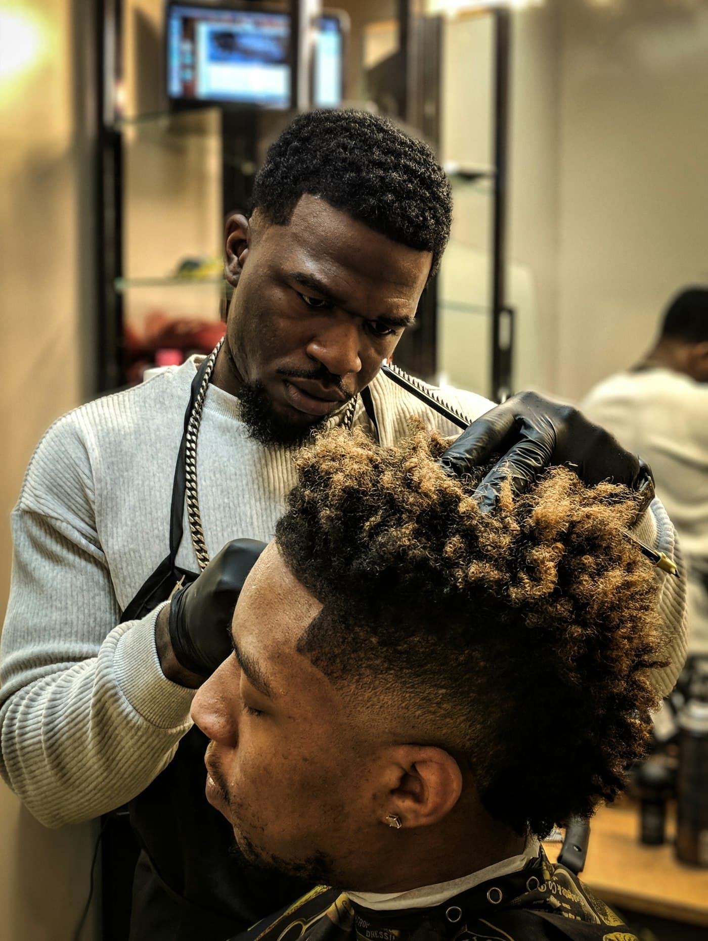 Close-up of a barber shaping a client's fade
